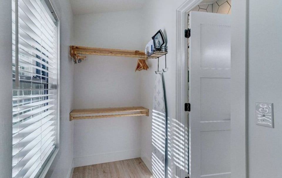 Make use of the laundry nook w/ shelves, iron, board & storage—ready!