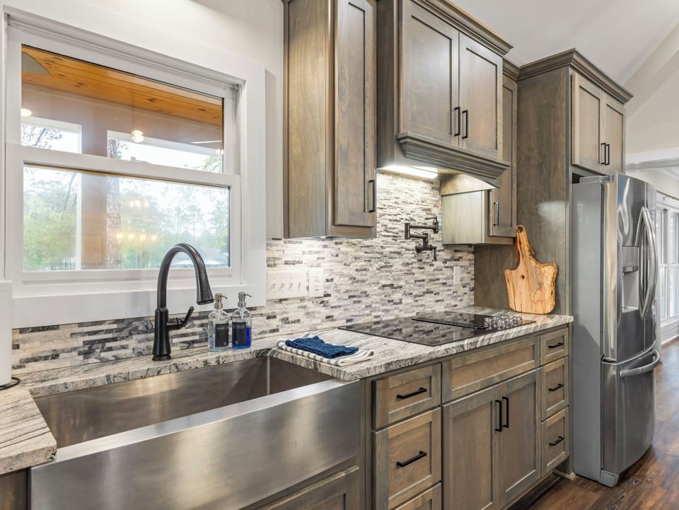There's lots of sink space with this stainless sink which is in close proximiy to the 6 burner flat top range with pot filling faucet. 