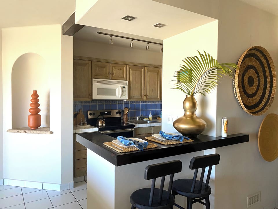 A chic two-seater nook overlooks the open kitchen perfect for morning pastries