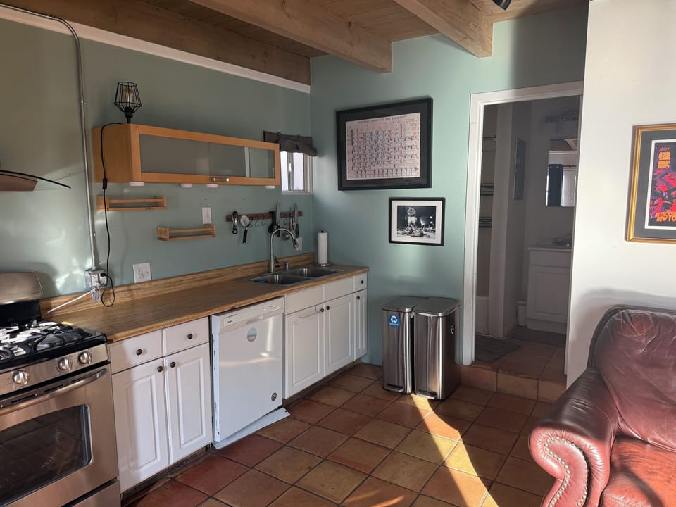 Full kitchen with stove, fridge, dishwasher & cooking supplies.