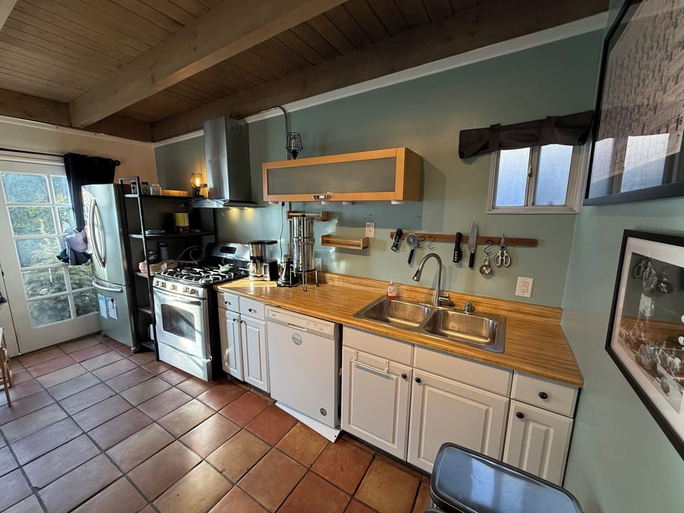 Full kitchen with stove, fridge, dishwasher & cooking supplies.