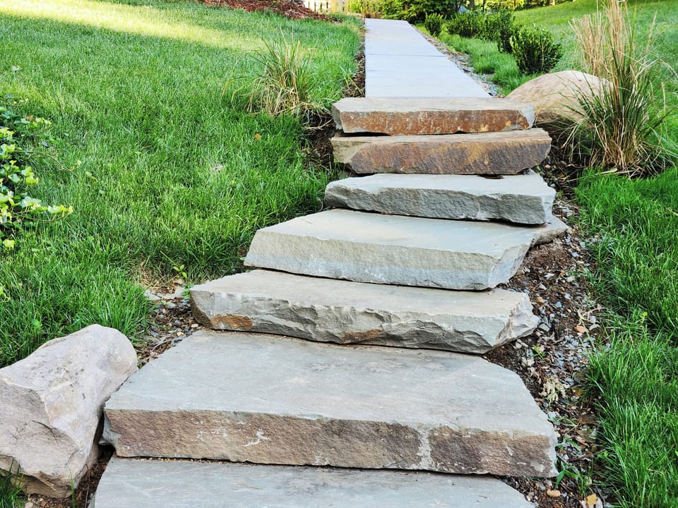 Private front entrance steps off of parking pad.