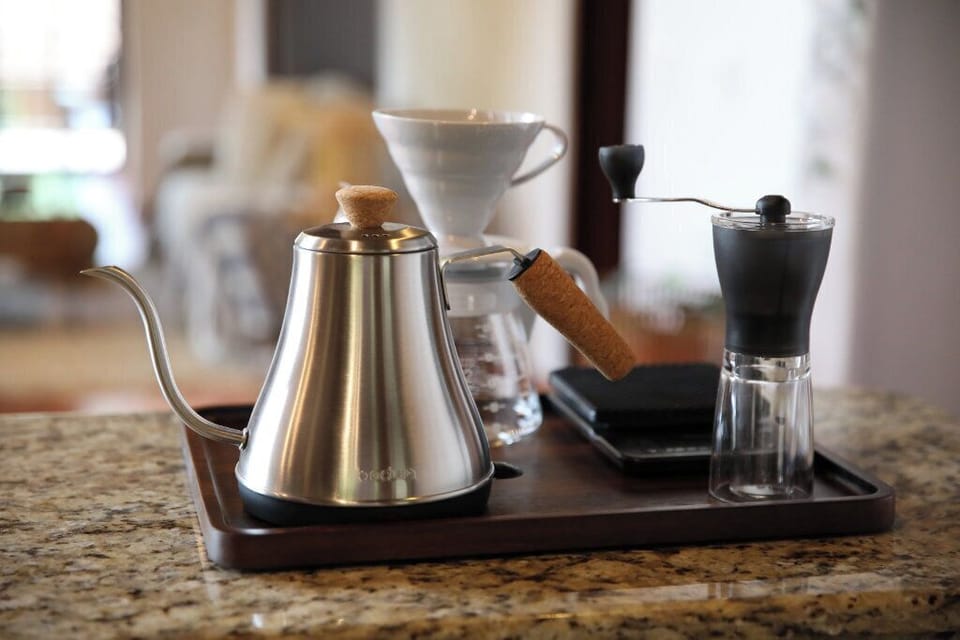 Full V60 pour-over setup with grinder, scale, kettle, filters, and more.