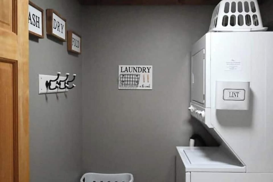 Laundry / Half Bath features a stacked washer and dryer.