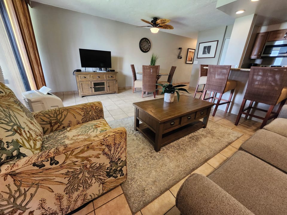 Living room area with portable AC and a pull-out sofa for extra guests.