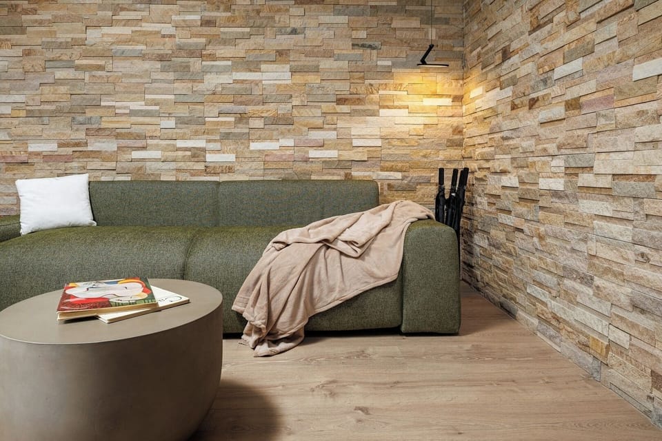 Cozy reading nook with a textured stone wall, ambient lighting, and a plush armchair — perfect for evening relaxation or quiet mornings with coffee and a book