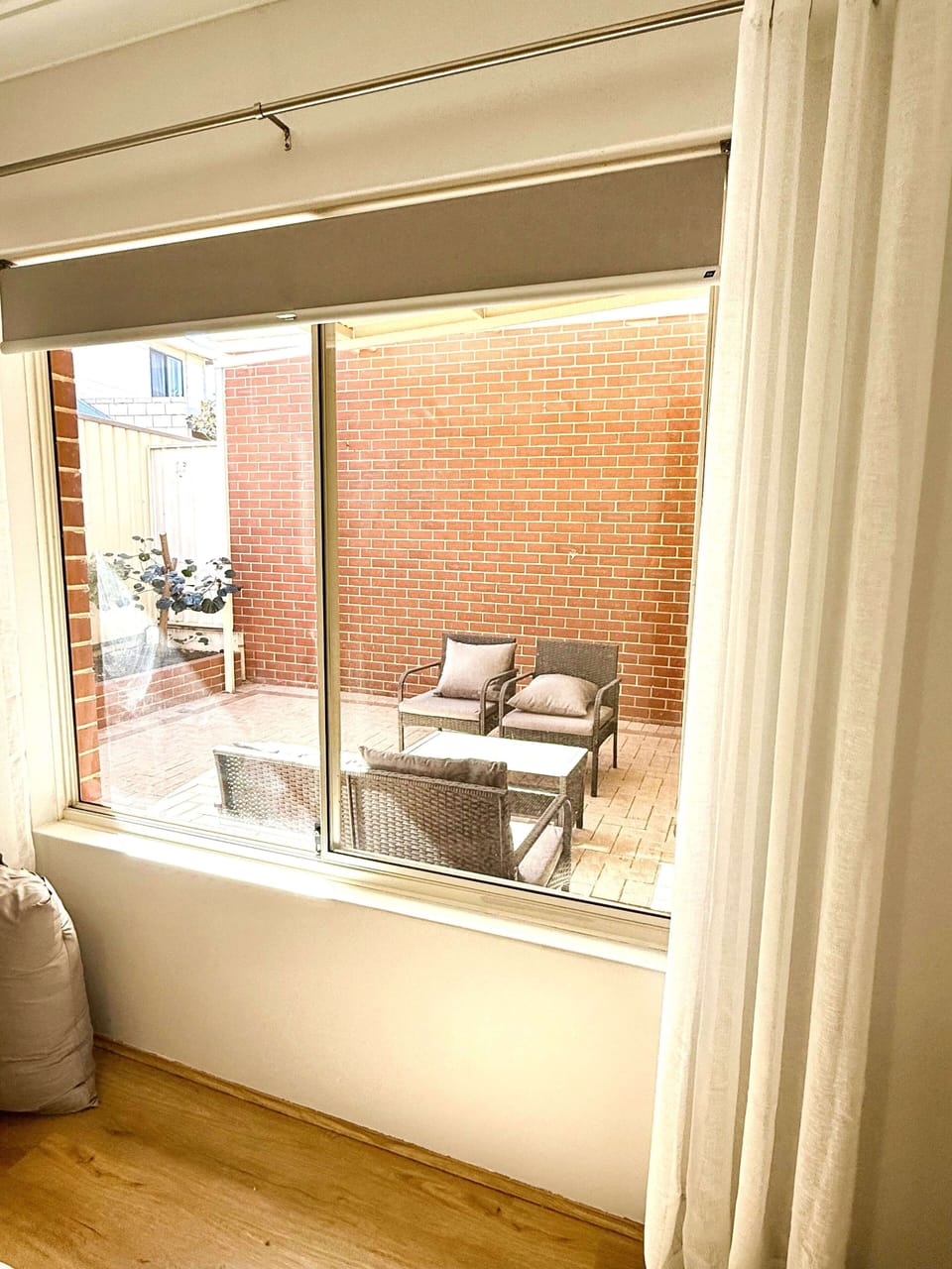 This apartment features a private balcony with comfortable tables and chairs, perfect for unwinding and enjoying the fresh air.