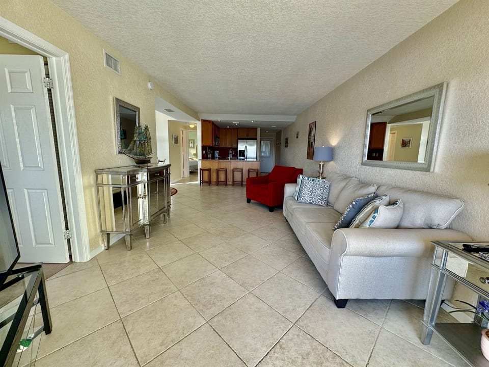 These floor-to-ceiling doors not only bathe the room in natural Florida sunlight but also create a seamless indoor-outdoor flow.