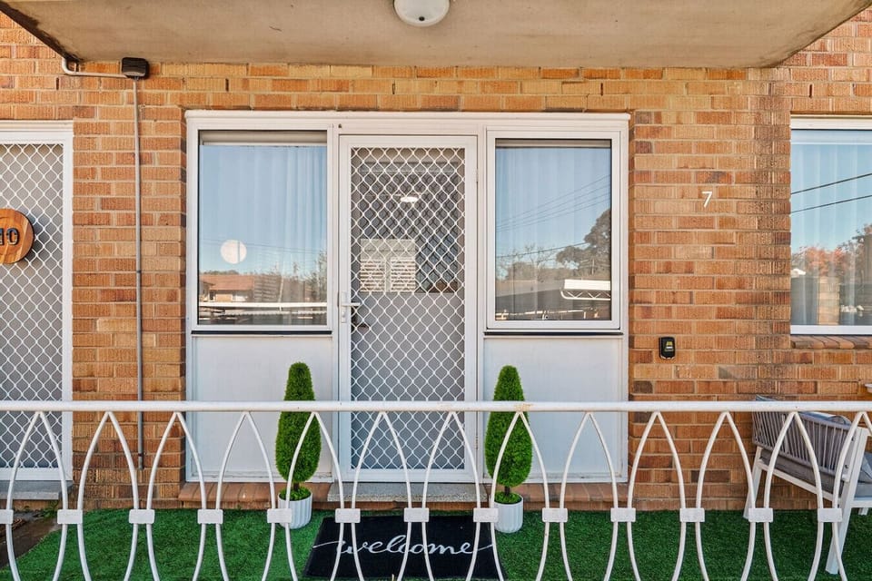 Outdoor balcony with a table and chairs, perfect for relaxing outside