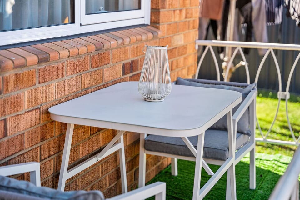Outdoor balcony with a table and chairs, perfect for relaxing outside