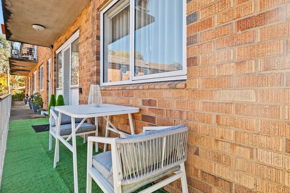 Outdoor balcony with a table and chairs, perfect for relaxing outside
