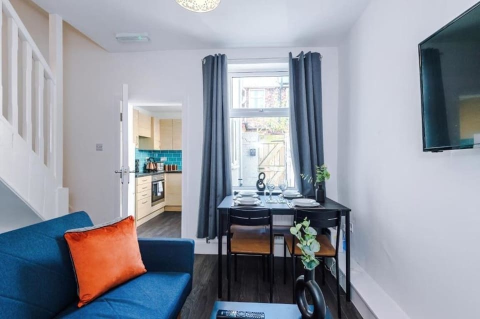 The dining area features a table with comfortable seating — perfect for enjoying meals, working remotely, or relaxing with a coffee.