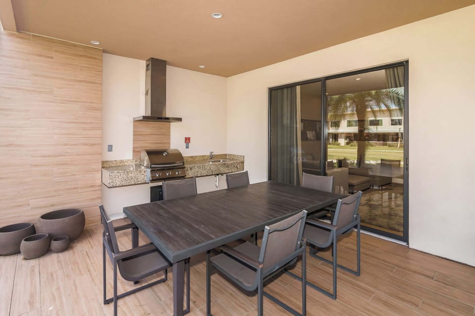 Patio with table, seating, and grill station