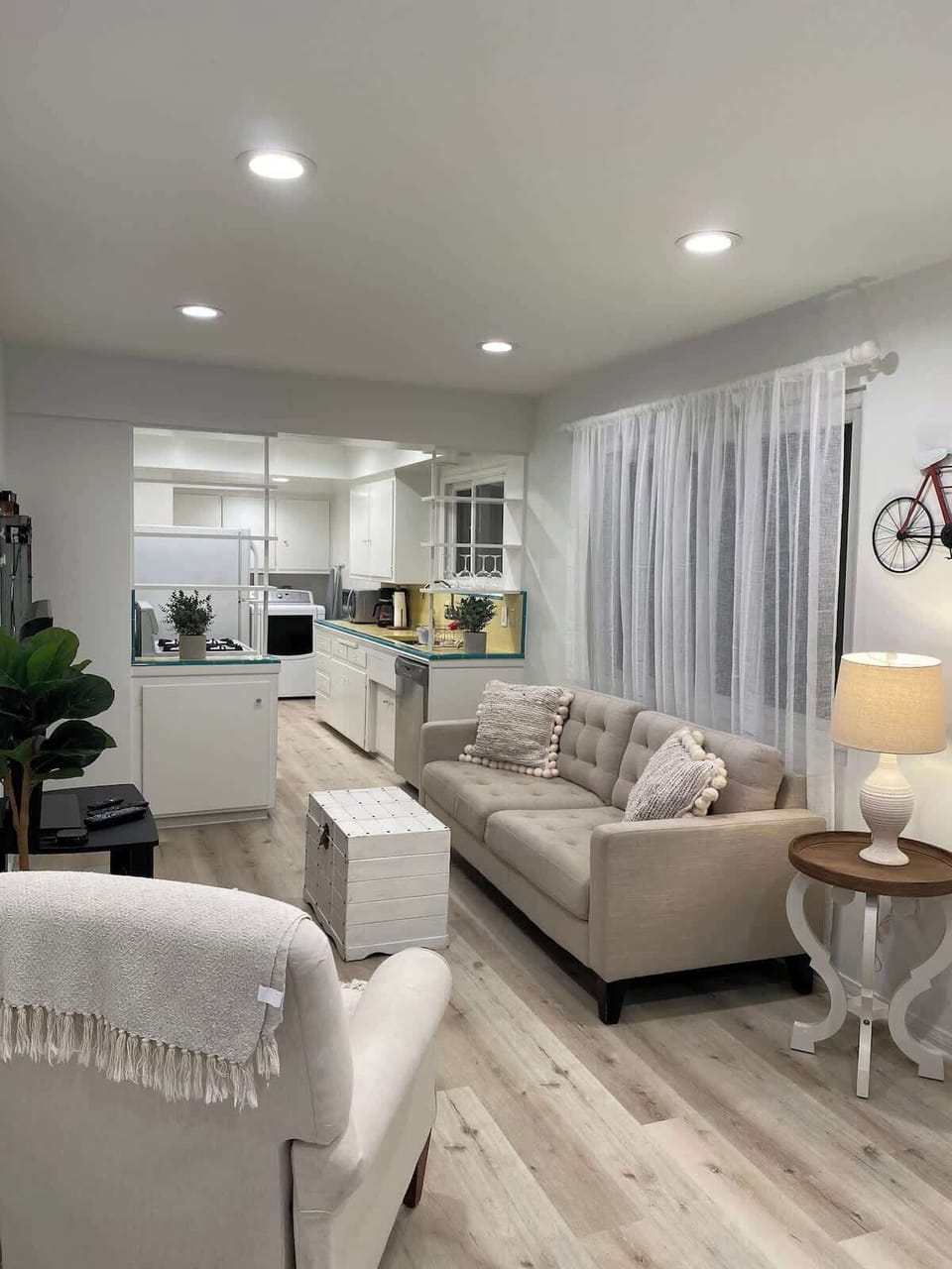 Living room...sofa...recliner chair...coffee table...tv stand w/48 " tv and Apple TV box...dining table and chairs in front of panoramic ocean view