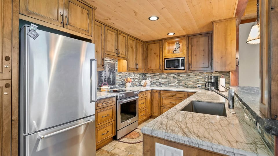 Beautifully upgraded kitchen with granite counters, custom cabinetry and stainless steel appliances