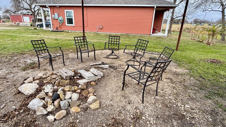Outdoor covered fire circle off living room side of house