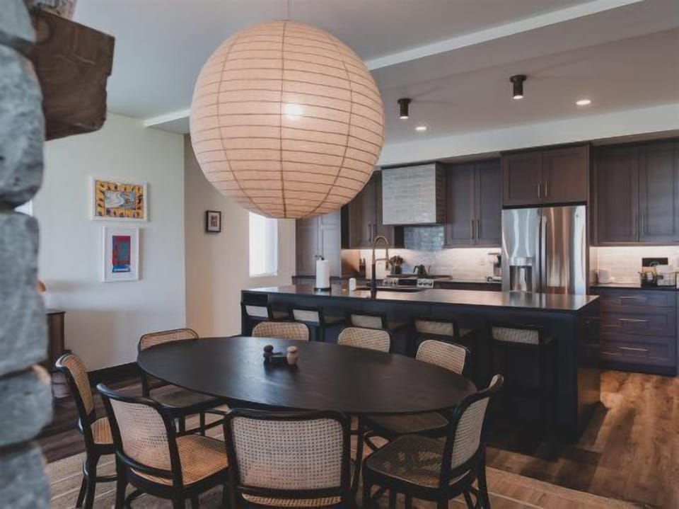 The kitchen and dining area are chic, modern spaces that are beautifully curated for your group's enjoyment. | Main Level