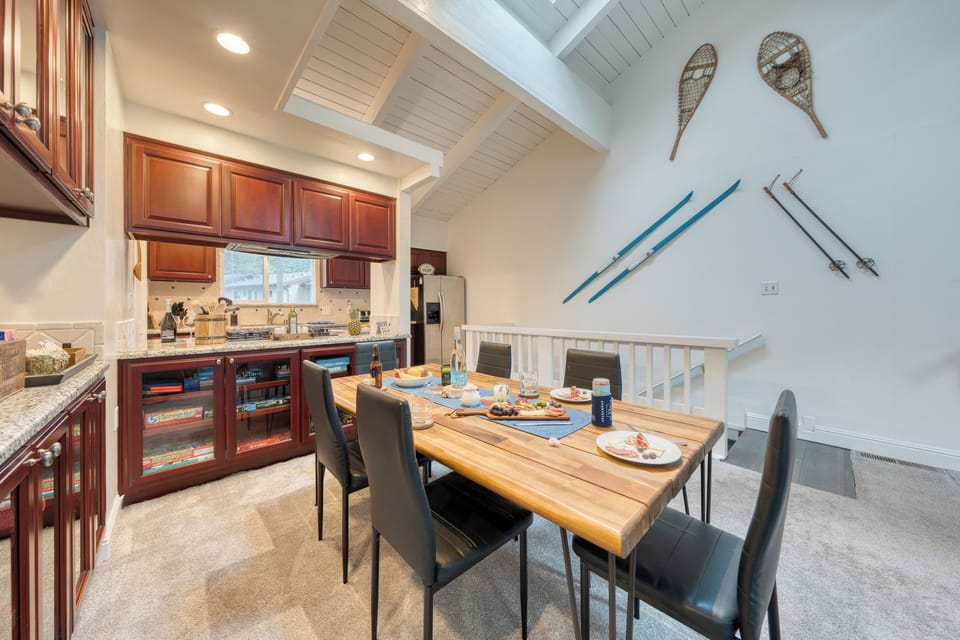 Dining and kitchen combo with wood cabinetry.