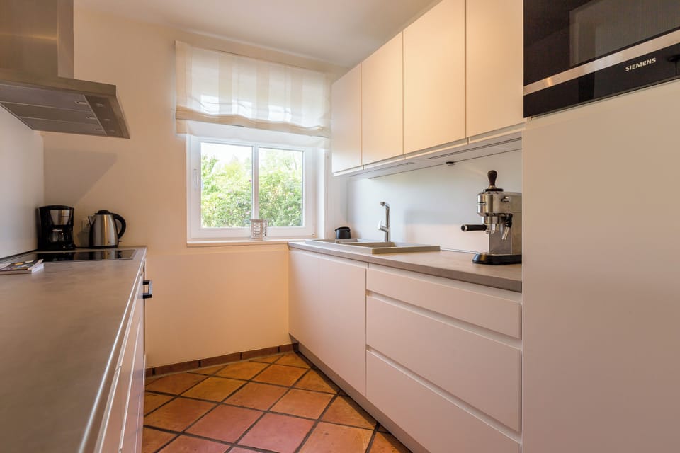 Modern Kitchen with Window and White Cabinets