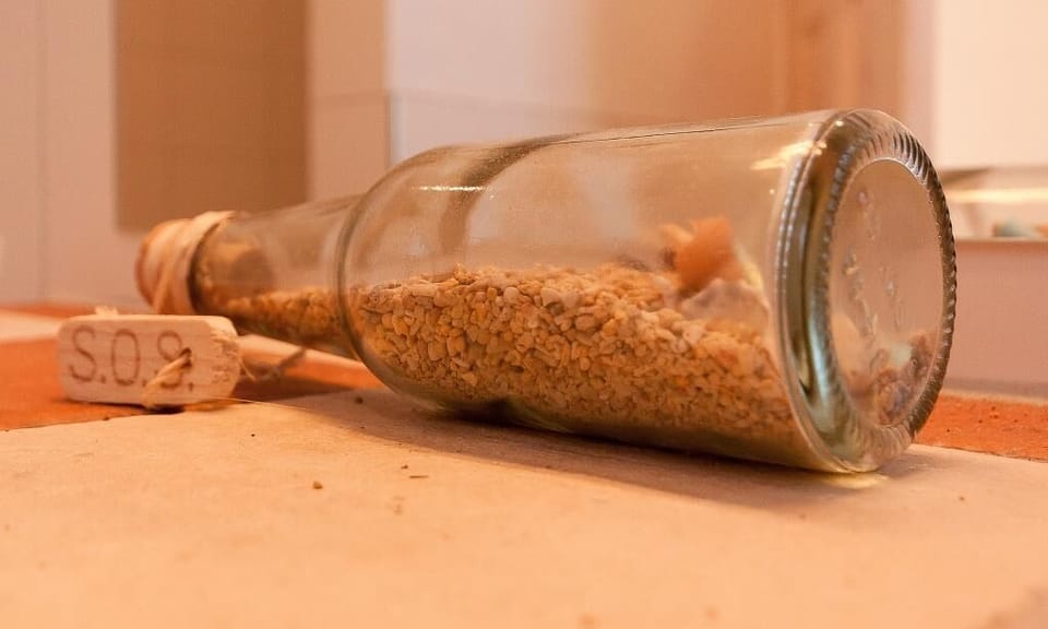 Bottle with Sand on a Table