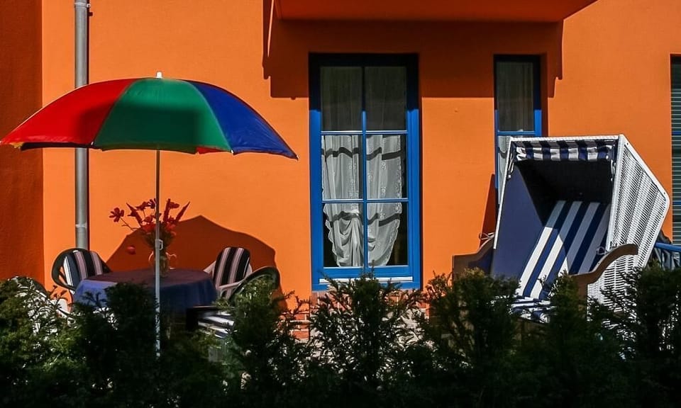 Terrace with table, chairs, and sunny sunshade
