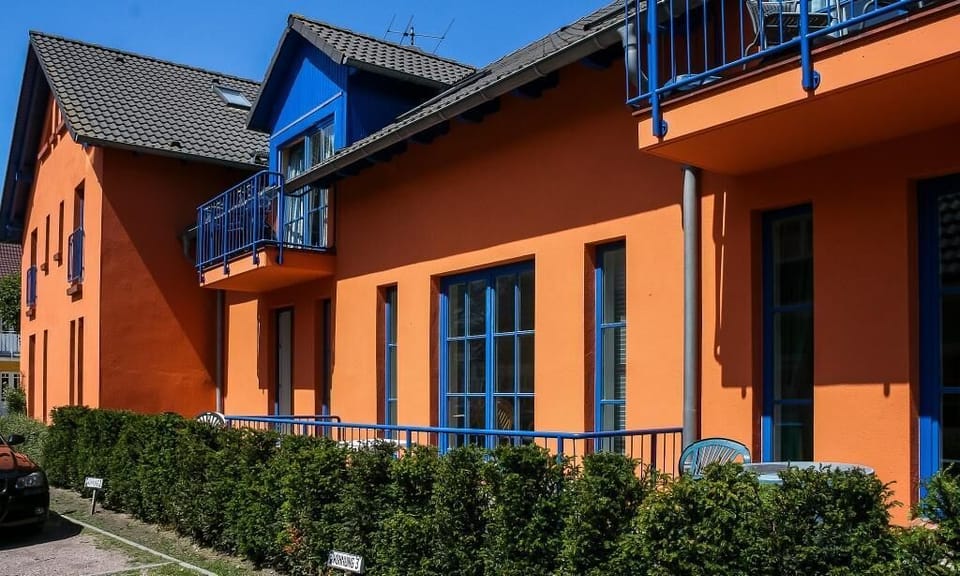 Colorful exterior view of a holiday home with balconies