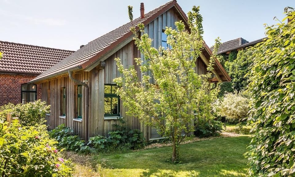 Exterior View of a Wooden House with Garden