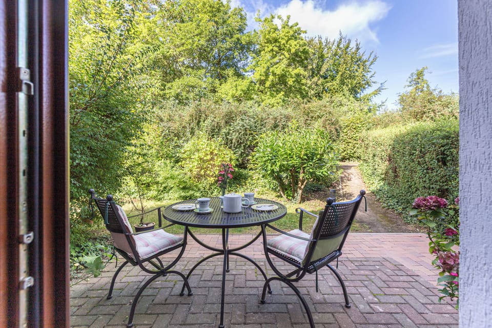 Terrace with Table and Chairs in Garden