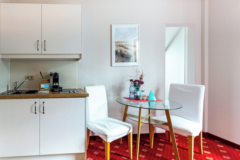 Kitchen with table and white chairs