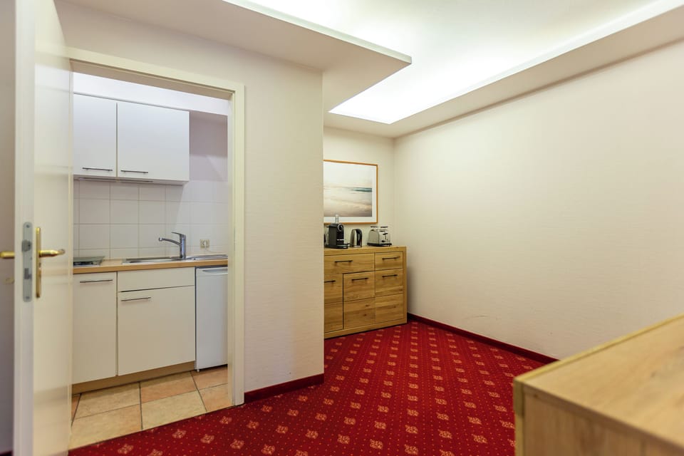 Kitchen with white cabinets and wooden shelves