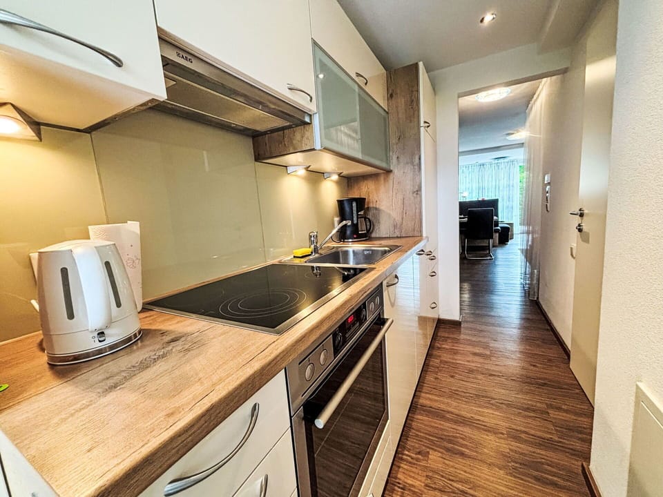 Flooring, Interior Design, Wood, Countertop, Floor, Kitchen, Room, Apartment, Major Appliance, Kitchen Appliance