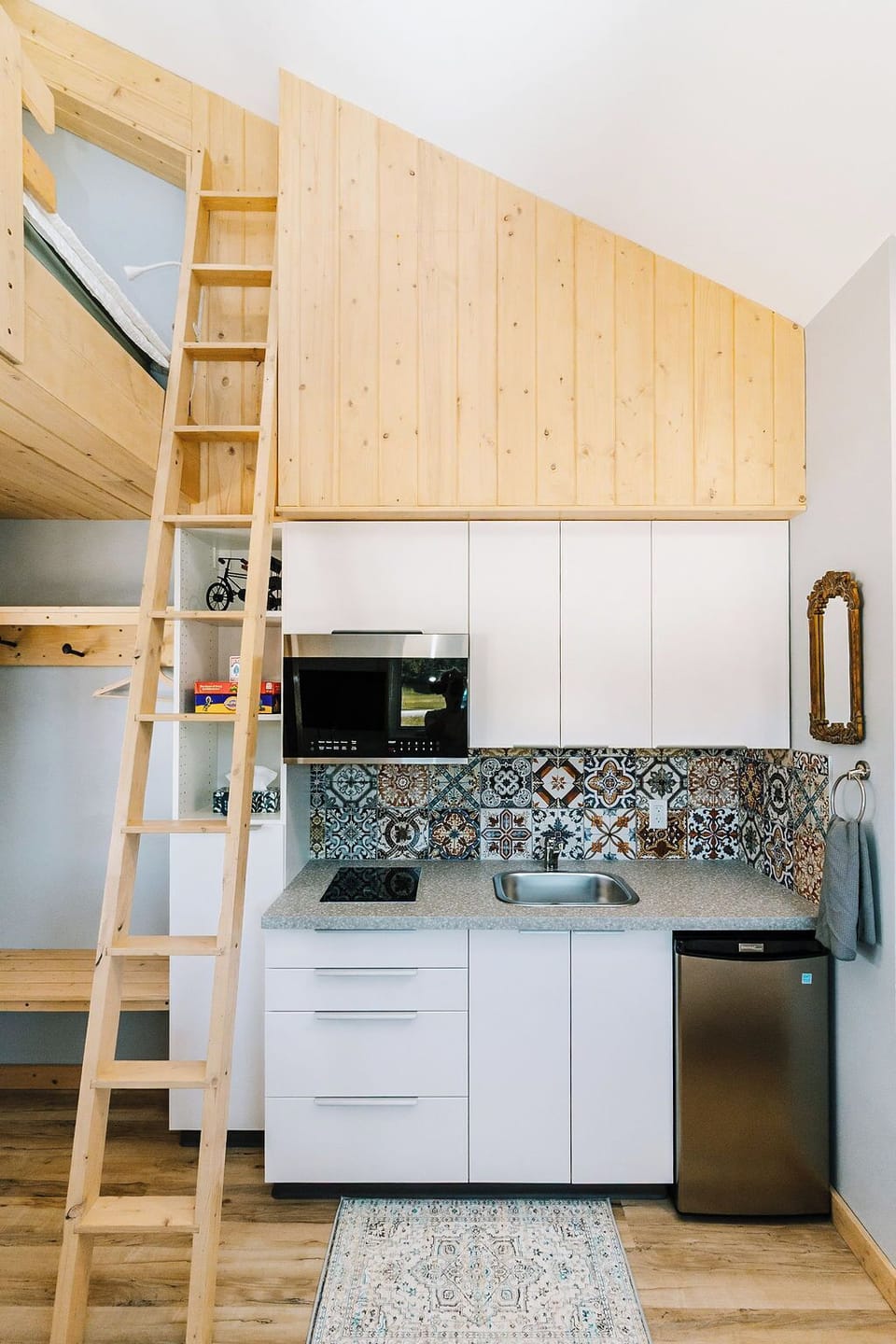 Front entrance, ladder to loft, kitchen