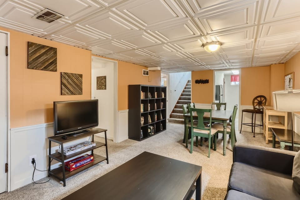Living room with dining area, Smart TV, and comfortable couch