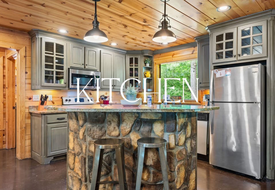 With a mix of natural stone and warm wood tones, the kitchen island doubles as a prep station and a social hub where everyone tends to gather.