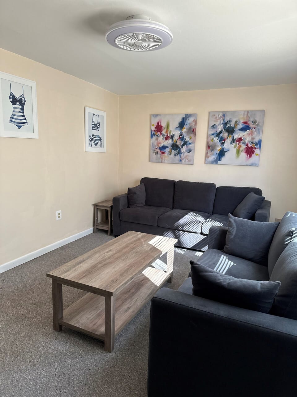 Open and comfy living room with big screen tv and remote, and family games.