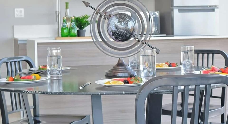 Contemporary dining area w/ stylish table & modern art display