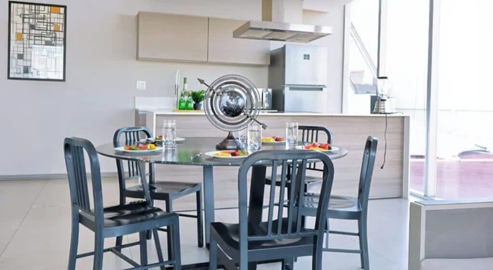 Bright dining area w/ round table beside the kitchen, perfect for relaxed meals together