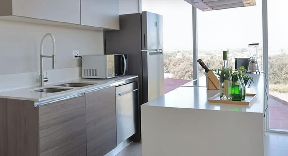 Sleek kitchen w/ modern cabinets, stainless range & bright window light