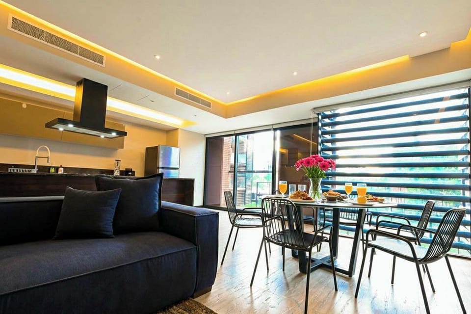 Bright dining area by large windows, perfect for relaxed breakfasts or evening meals
