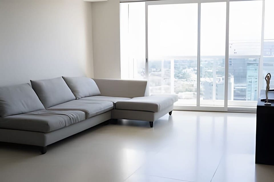 Modern lounge area w/ sectional sofa set beside large windows & sweeping views