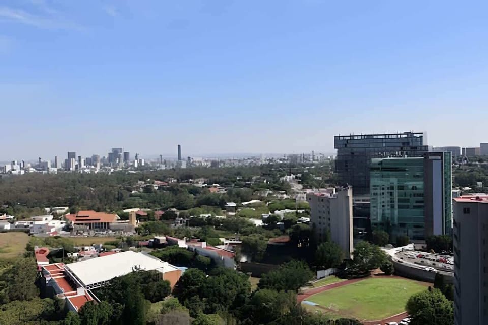Wide city skyline views capturing surrounding buildings & green spaces below