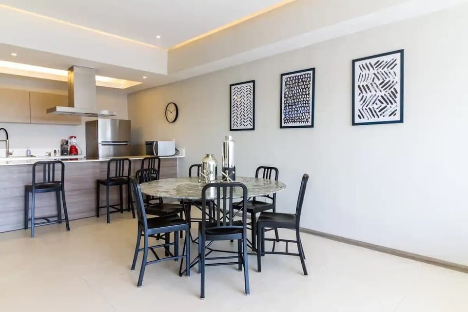 Open dining space w/ table seating flowing easily into the kitchen