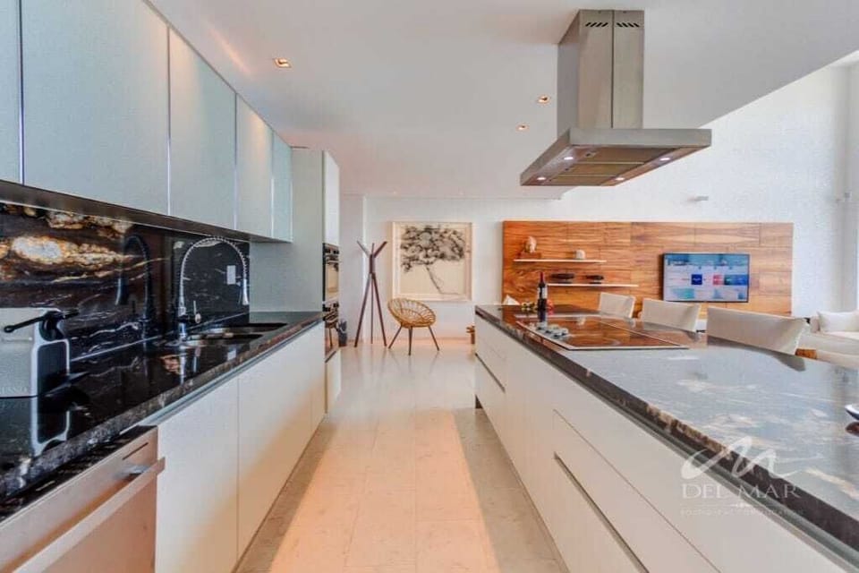 Sleek kitchen w/ long island, modern appliances & open layout perfect for cooking together
