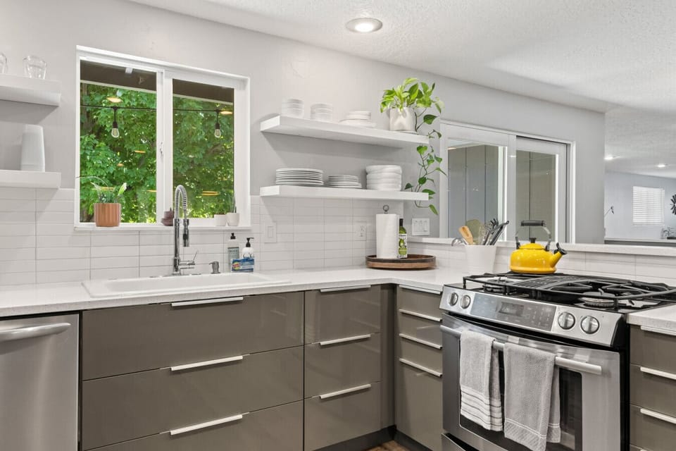 Gas range, full appliances, and a window above the sink.