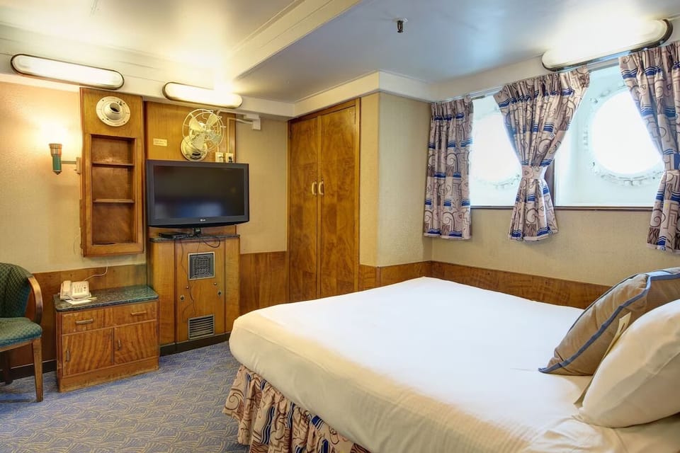 Relax into crisp linens beside bright windows and easy entertainment.