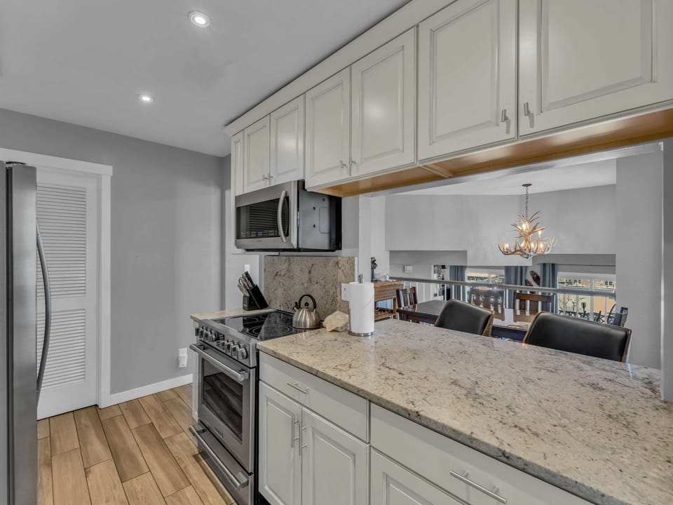 Kitchen: Main floor, drip coffee maker, Keurig, toaster, cooking utensils, tableware