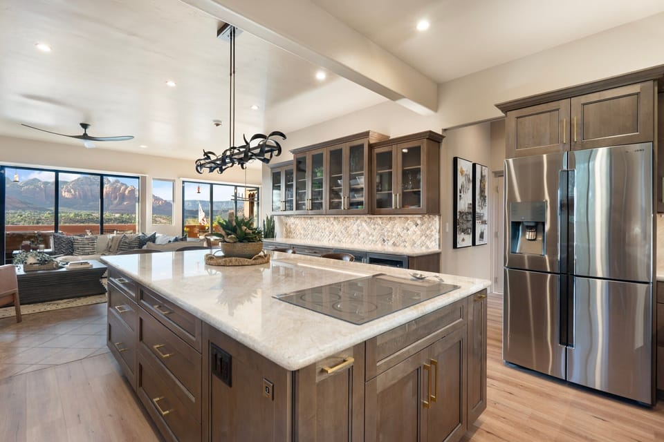 Fully stocked kitchen with stainless steel appliances & oversized island.