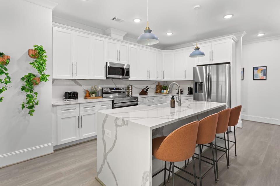 Cook, sip, and connect in this stunning modern kitchen featuring luxe marble countertops, stainless steel appliances, and cozy bar seating perfect for morning coffee or evening cocktails. Whether you're a foodie or just here for the vibes, this space has everything you need to feel right at home.