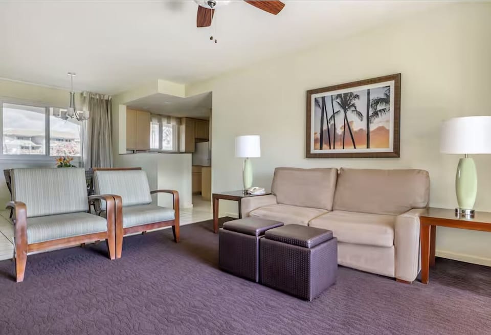 Unwind on plush seating in a bright, airy suite.