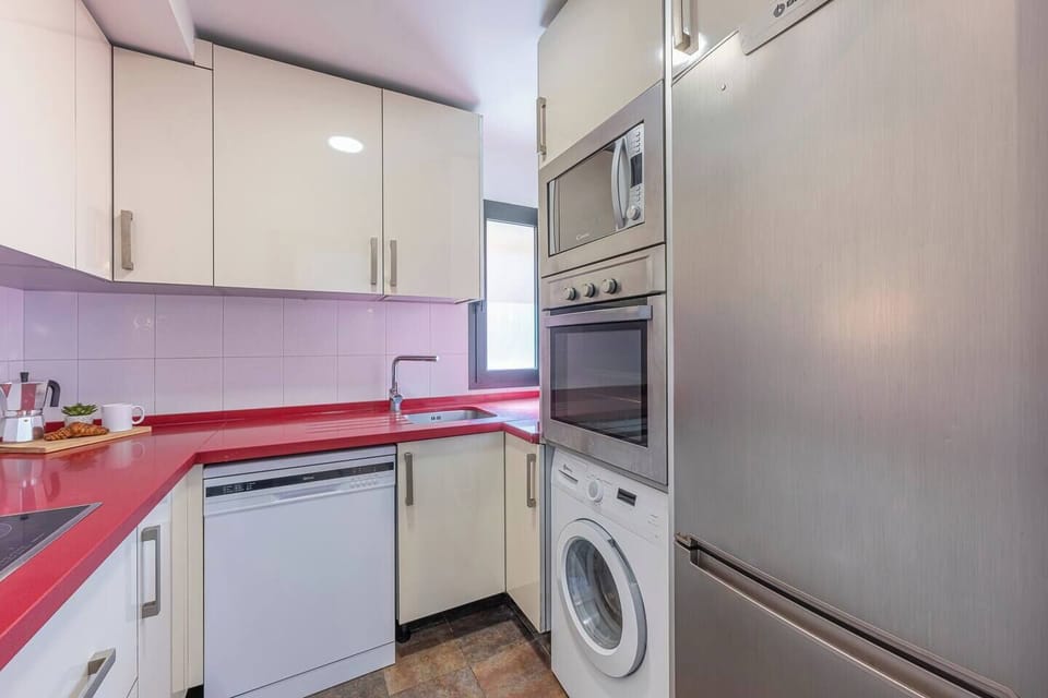 Fully equipped kitchen with appliances and storage space. (2)